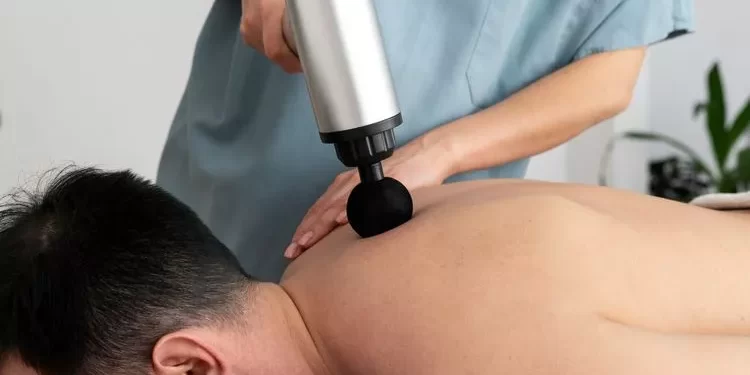 person using massage gun