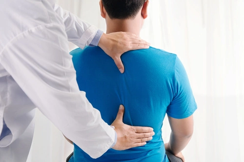 physiotherapist massage on man's back