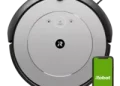 A sleek, modern robot vacuum effortlessly cleaning a living room floor, showcasing the ROOMBA i1's efficiency and convenience.