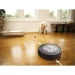 A robotic vacuum navigating through a modern living room, showcasing the efficiency of the iRobot Roomba j7 Robot Vacuum.
