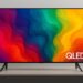Samsung QLED TV on a stand displaying a vibrant multicolor abstract pattern with thin bezels and modern design.