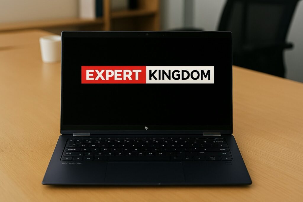 HP OmniBook X Flip 2‑in‑1 laptop on a wooden desk in a modern office, with the Expert Kingdom logo displayed on the screen