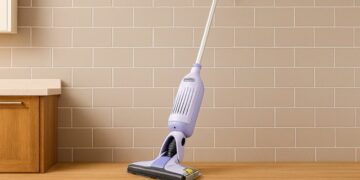 Shark VacMop 2‑in‑1 cordless vacuum spray mop standing against a kitchen wall
