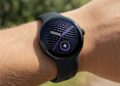Person wearing Google Pixel Watch 5 outdoors showing sleek black design and curved display