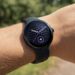 Person wearing Google Pixel Watch 5 outdoors showing sleek black design and curved display