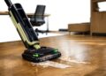Tineco FLOOR ONE S7 Master wet and dry vacuum cleaner cleaning a spill on hard flooring in a modern office environment