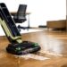 Tineco FLOOR ONE S7 Master wet and dry vacuum cleaner cleaning a spill on hard flooring in a modern office environment